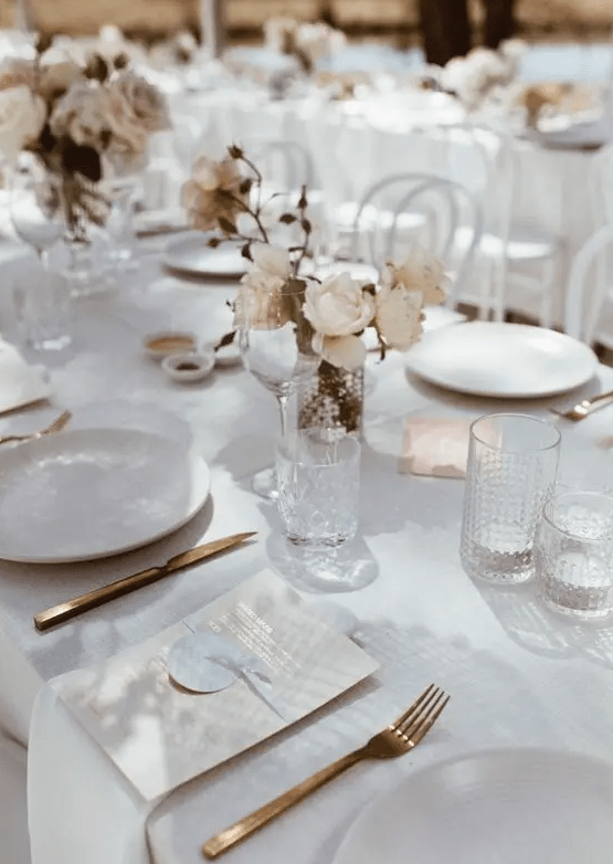a simple white wedding table setting