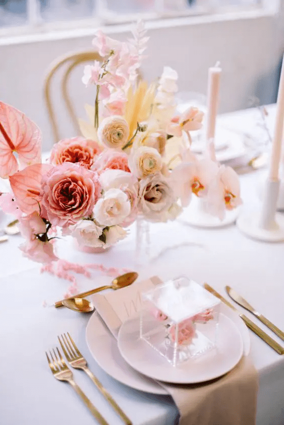 a beautiful ombre floral wedding centerpiece of pink, blush and white blooms with a pretty shape is great for Valentine’s Day