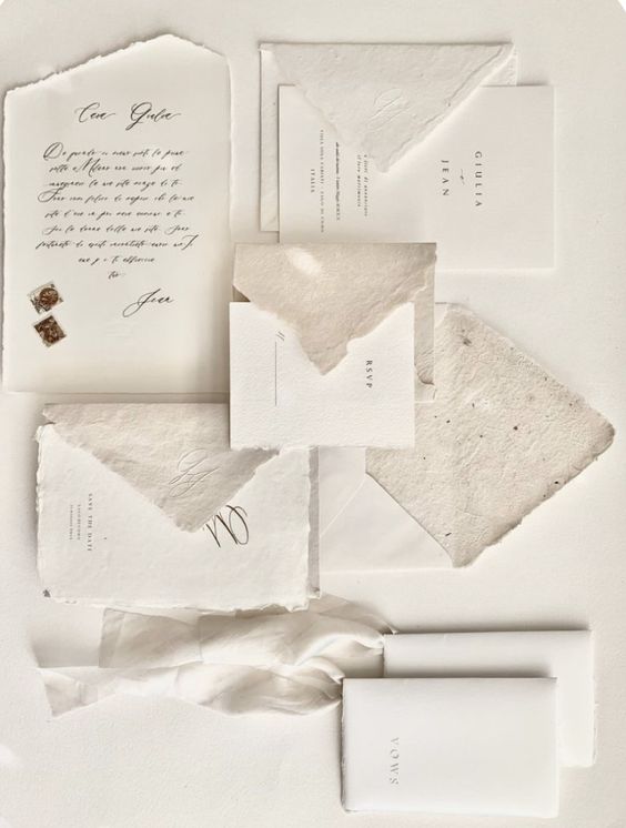 a beautiful textured wedding invitation suite with a raw edge and textural paper, black calligraphy is amazing