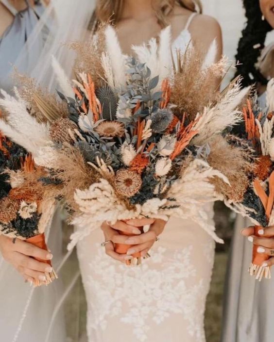a boho wedding bouquet of pampas grass, dried flowers and leaves is a stylish solution for a boho wedding
