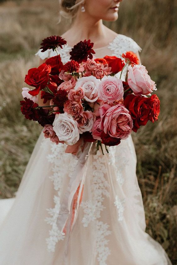 a bold modern wedding bouquet of pink, white and red roses, dahlias and peonies is a cool and colorful arrangement to rock