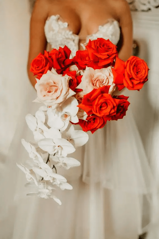 a bold wedding bouquet of white orchids, blush and red roses is a fantastic idea for a wedding