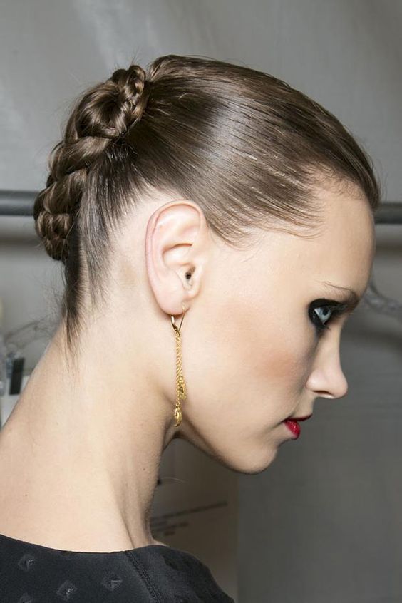 a braided updo with a sleek top is a super cool hairstyle for a modern or minimalist wedding