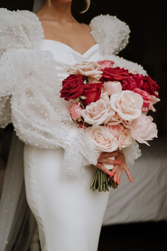 a bright modern wedding bouquet of red and blush roses is a bold and chic idea for a modern bride