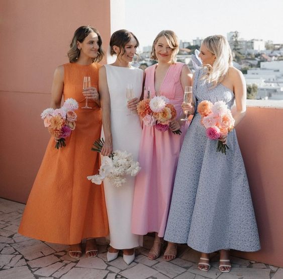 a chic pastel pink and blue midi bridesmaid dress, an orange one for a modern wedding infused with color