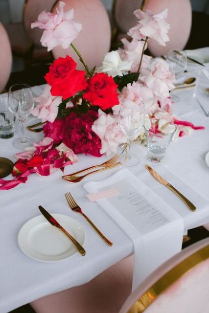 a contrasting wedding centerpiece of blush and red roses and a burgundy peony is adorable for a modern wedding