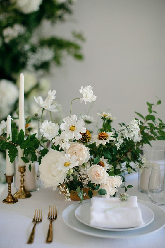 a delicate wedding centerpiece of blush peonies, white roses, cosmos and fillers is a cool idea for spring and summer