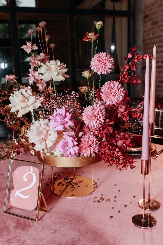 a fantastic modern ombre wedding centerpiece from neutral to pink and red, with roses and some other blooms