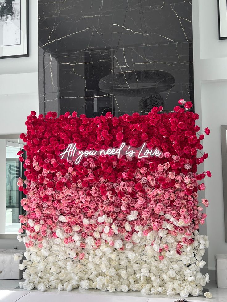 a fantastic ombre wedding floral wall from red to pink and white and a neon light is a gorgeous and bold decoration to rock