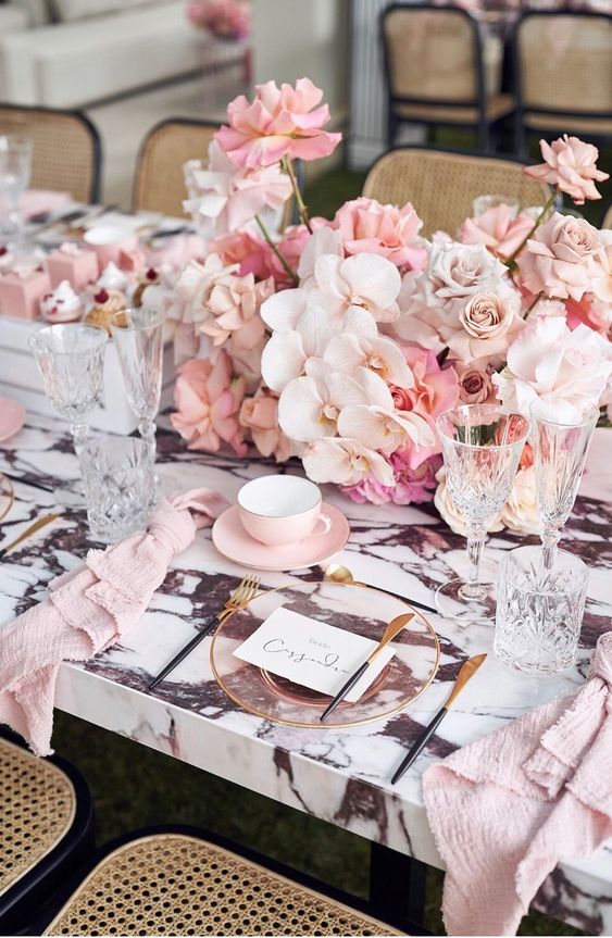 a fantastic pink wedding centerpiece of blush and pink roses and white orchids is a very sophisticated decoration