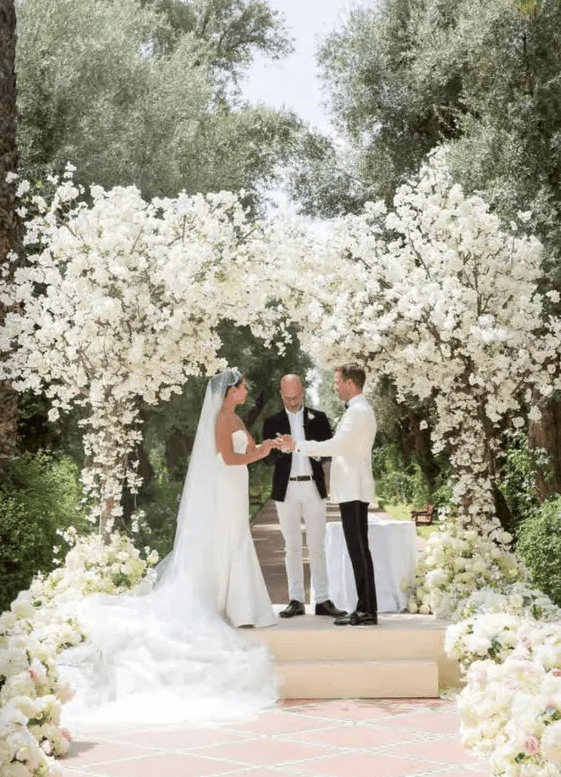 a gorgeous lush wedding arch covered with white blooms and blooming branches is a fantastic idea for any formal wedding