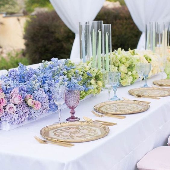 a gradient wedding centerpiece from lilac to blue and ivory is a stunning idea for spring and summer weddings