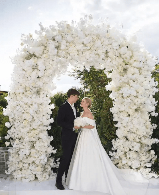 A jaw dropping white wedding arch completely covered with white blooms is a fantastic idea for a refined wedding