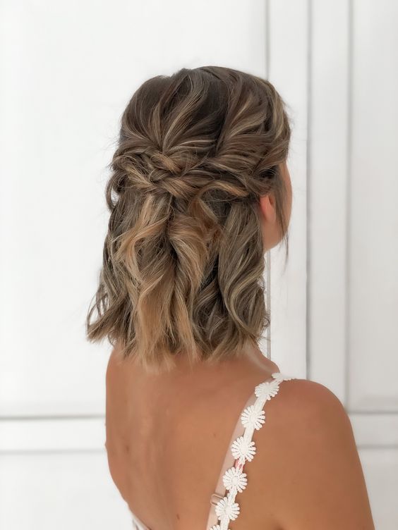a lovely half updo with a double twisted halo and curls down plus a bump on top is a cool and chic idea