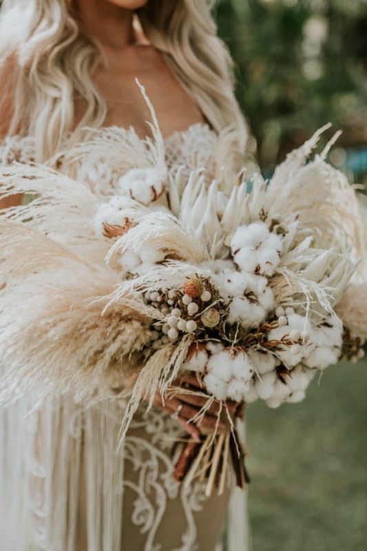 a lush boho wedding bouquet of pampas grass, cotton, berries is a gorgeous solution for a neutral wedding