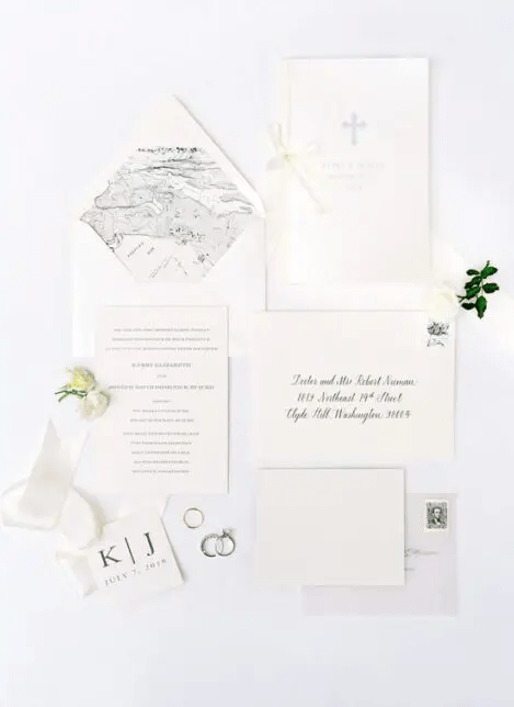 a modern and classic neutral wedding invitation suite with map lining, black calligraphy and prints is a great idea for a summer wedding