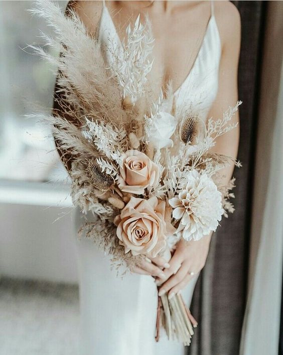 a neutral boho wedding bouquet of blush and white roses, a dahlias, grasses and pampas grass is a lovely idea
