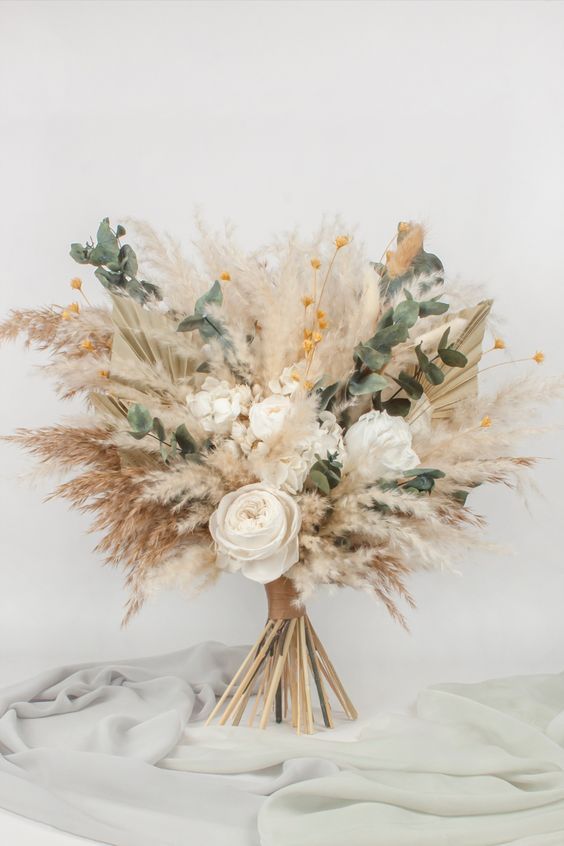 a neutral boho wedding bouquet of pampas grass, white roses and greenery is a stylish idea for a boho wedding