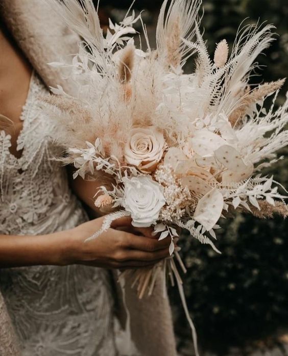 a neutral boho wedding bouquet of white and blush blooms, pampas grass and lunaria is a cool idea for a boho wedding