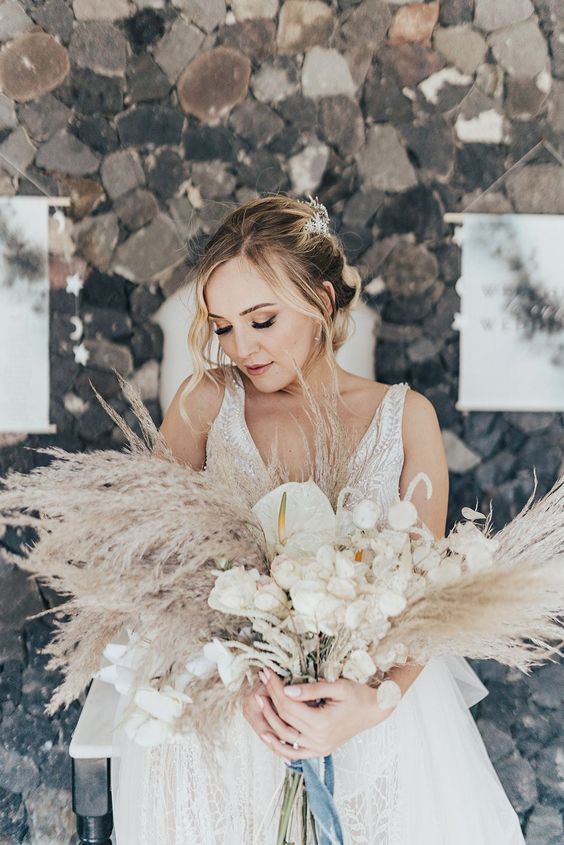 a neutral wedding bouquet of pampas grass, white blooms, anthuriums is amazing for a boho wedding