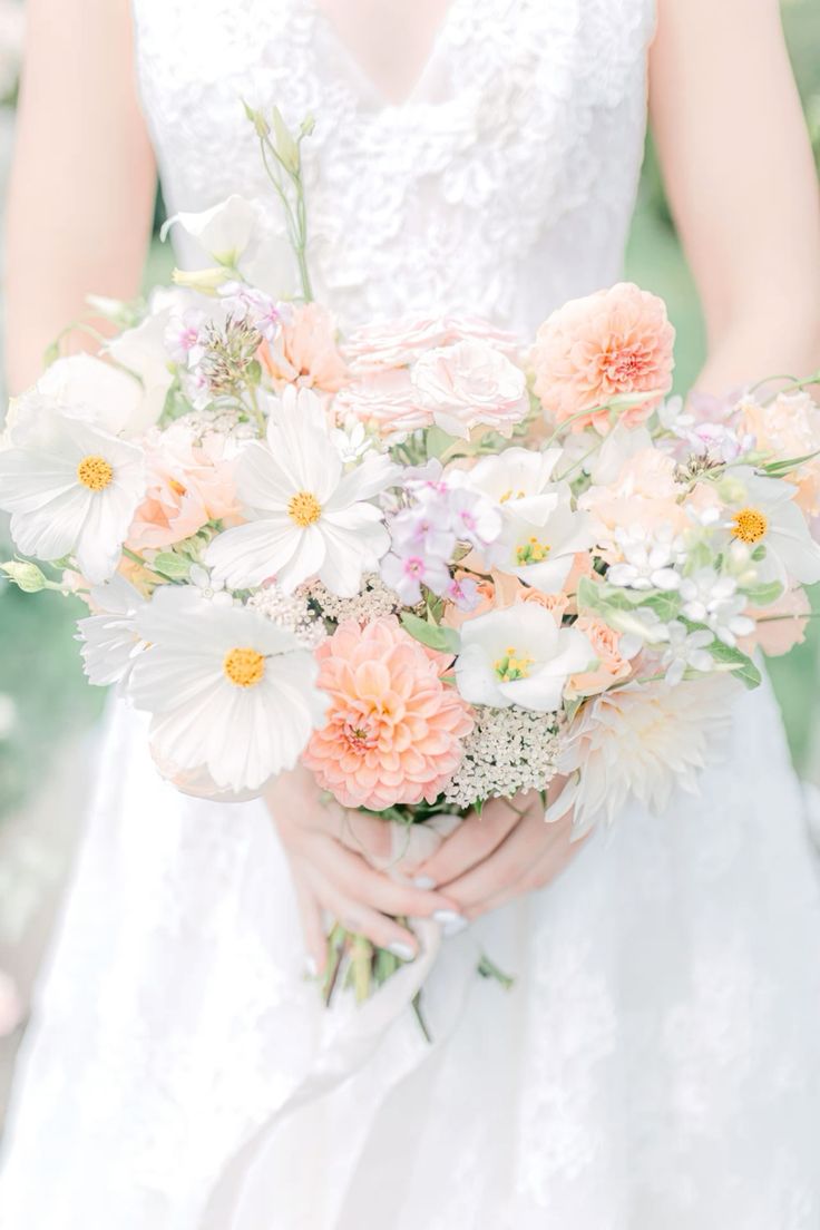 a neutral wedding bouquet of white cosmos, peachy dahlias and neutral fillers is a cool idea for spring