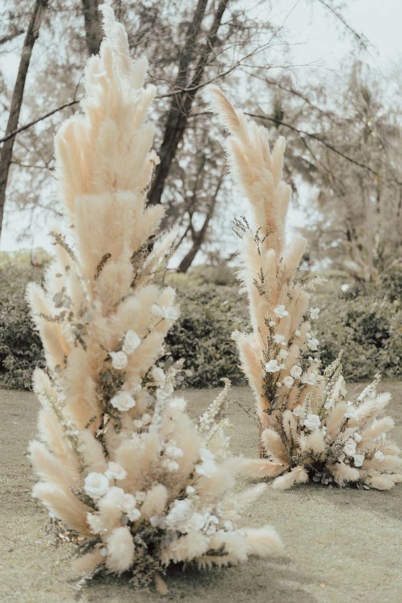 a pampas grass wedding altar with white blooms is a cool idea for spring, summer or fall is a cool idea for a boho couple