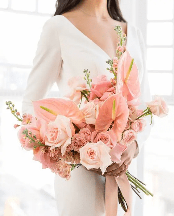 a pink wedding bouquet of roses and anthurium is a lovely and cute idea for a bride who loves pink