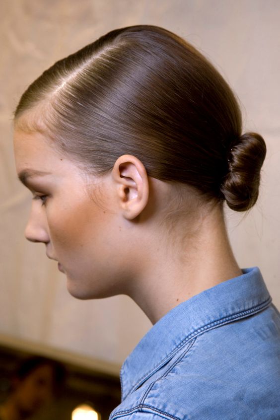 a pretty low ballerina bun with a sleek top and side parting is an amazing minimalist wedding hairstyle from short to medium hair
