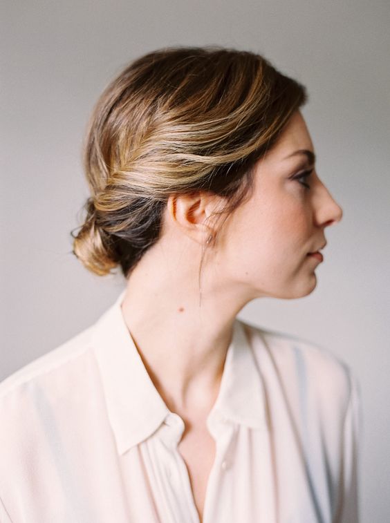 a pretty low bun with twisted touches and a bump on top is a cool hairstyle for a wedding, great for short and medium hair