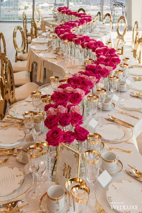 a refined and bold wedding centerpiece of lights and hot pink roses is a cool and catchy decor idea for a refined and glam wedding