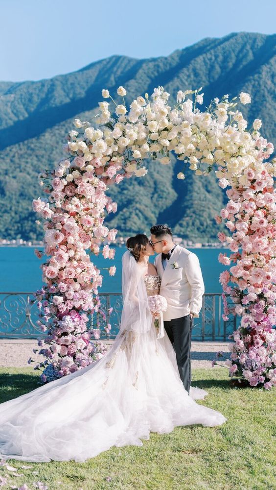a refined and delicate ombre wedding arch from lilac to blush and ivory plus a lake view is absolutely jaw-dropping