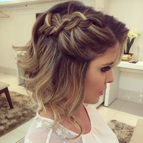 a short A-line half updo with a loose braid on one side and waves down is a cool hairstyle for a wedding