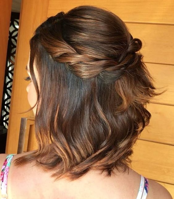 a short half updo with a bump on top and a braided halo, some waves down and face-framing hair is amazing
