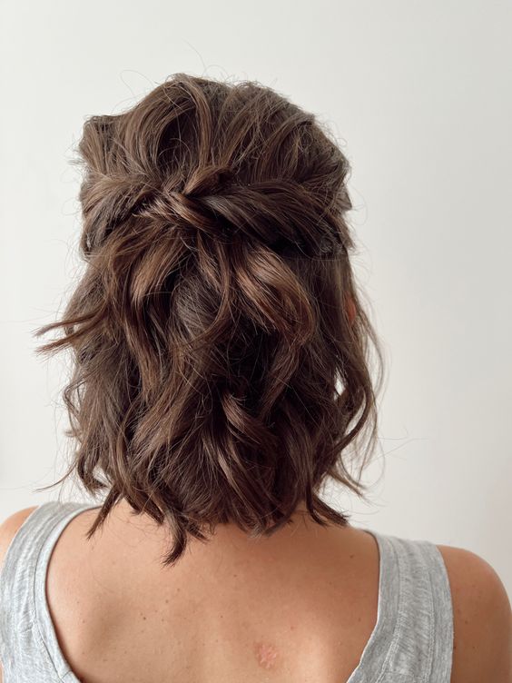 a short half updo with a bump on top, some twists and waves down is a cool and a bit messy hairstyle to rock
