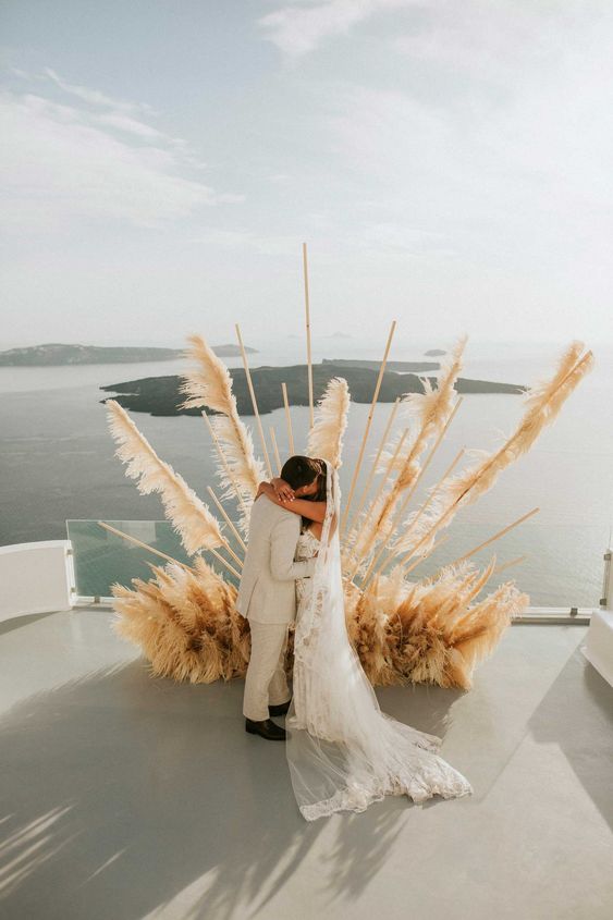 A spectacular pampas grass wedding altar with a sea view is jaw dropping and very statement like