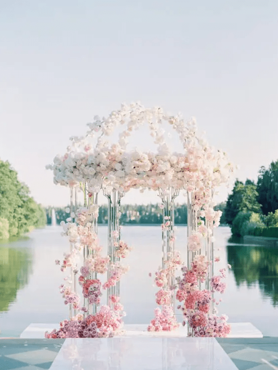 a stunning ombre acrylic wedding arch from lilac and pink to blush and ivory plus a lake view is a gorgeous idea, it seems floating