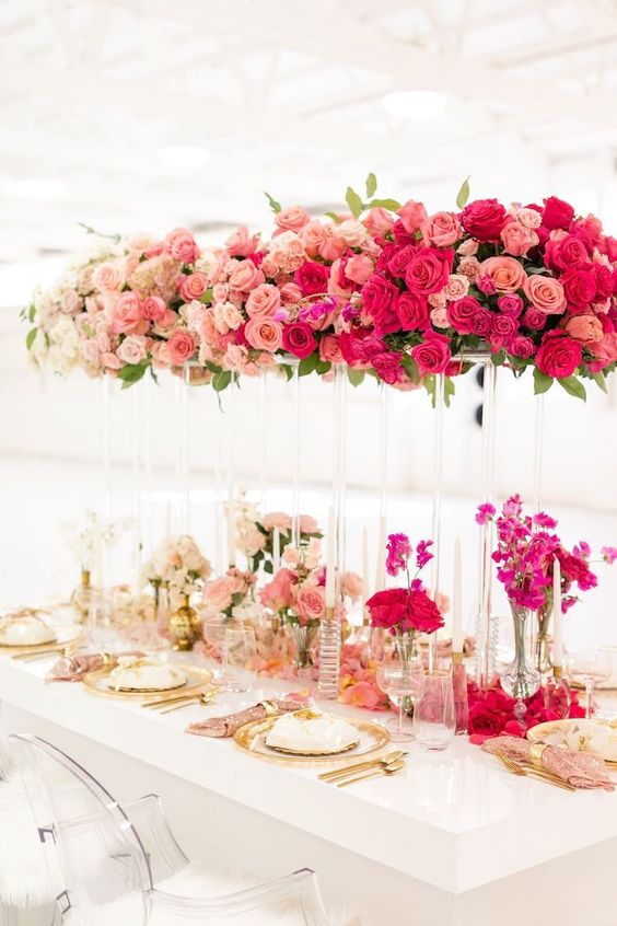 a tall ombre wedding centerpiece from ivory to pink and hot pink is a fantastic idea for a bold and refined modern wedding