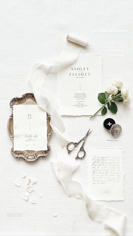 a white textural wedding invitation suite with a raw edge and black letters and calligraphy is refined and beautiful