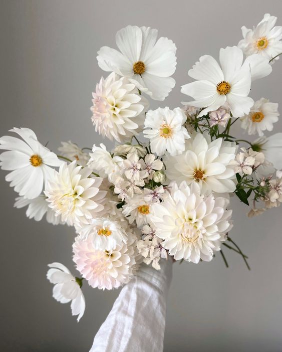 a white wedding bouquet of cosmos and dahlias is a great idea for a neutral wedding
