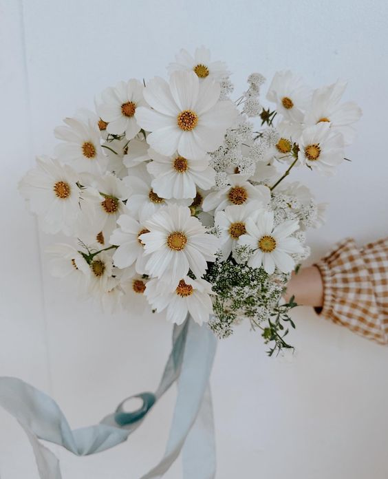 a white wedding bouquet of cosmos and some fillers is a pretty idea for spring and summer