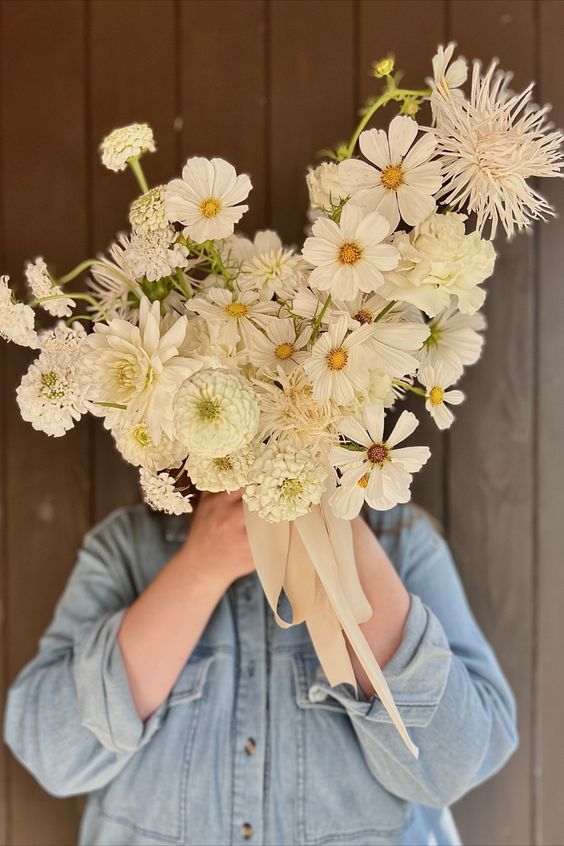 a white wedding bouquet of cosmos, dahlias and mums is a lovely idea for spring and summer, it looks super cool