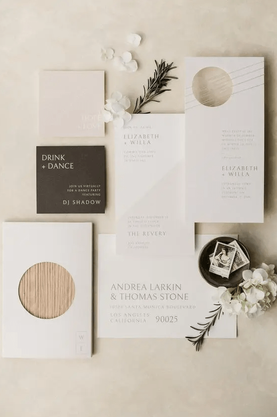 an ethereal neutral wedding invitation suite with a dark envelope, a bit of wood and some color blocking