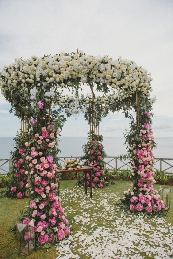 an ombre wedding altar from pink and to yellow and white is a gorgeous idea for a refined and flower-filled wedding