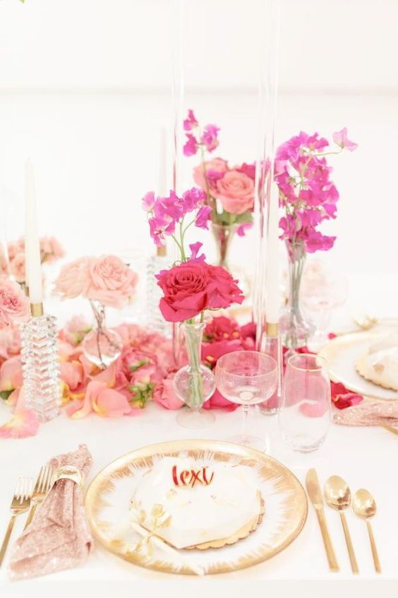 an ombre wedding centerpiece from blush to pink and hot pink is a cool and catchy bright decor idea for a colorful wedding