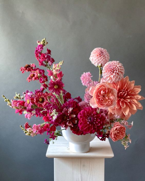an ombre wedding centerpiece from burgundy to blush and peachy, with dahlias and mums is amazing for summer or fall