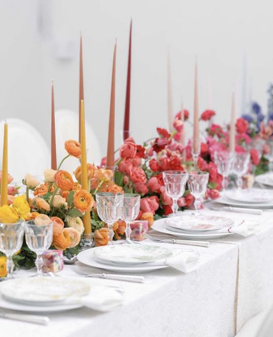 an ombre wedding centerpiece from yellow to orange, pink and red plus lilac is a stunning idea for a modern colorful wedding