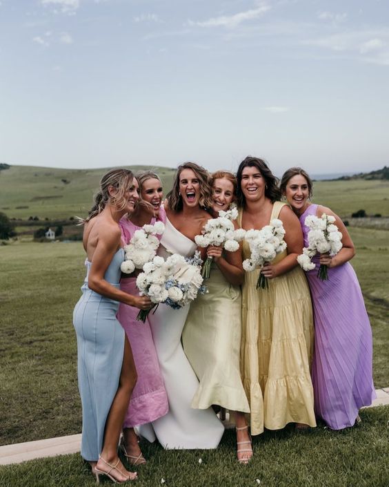 beautiful mismatching pastel midi and maxi bridesmaid dresses are fantastic for a spring or summer wedding