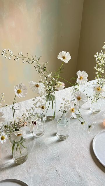 cluster wedding centerpieces of white cosmos and other blooms are great for spring and summer, they look chic