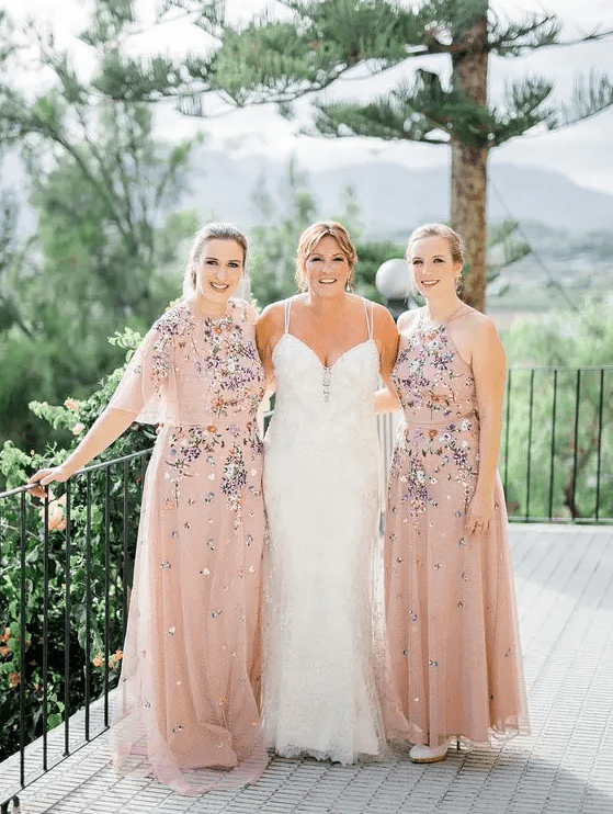delicate and beautiful blush maxi bridesmaid dresses with lovely and bold floral embroidery are amazing