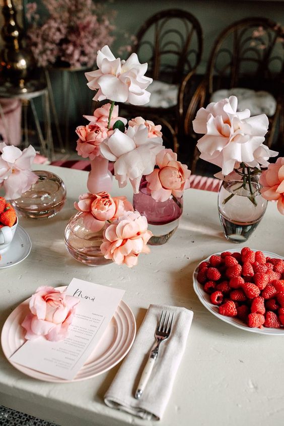 Delicate cluster wedding centerpieces of blush and peachy roses in clear vases are adorable, chic and very eye catching